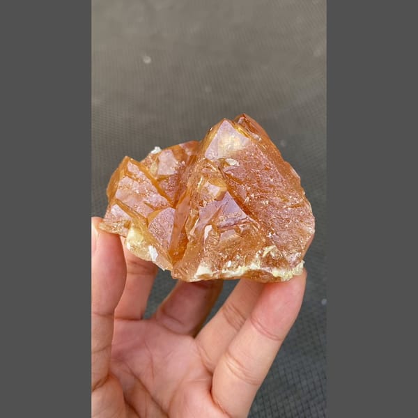 Orange scheelite floater with translucent tip from Xuebaoding, Sichuan — detail view