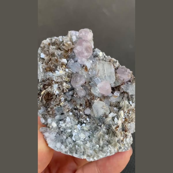 Pale violet apatite with aquamarine on mica from Xuebaoding, Sichuan — alternate view