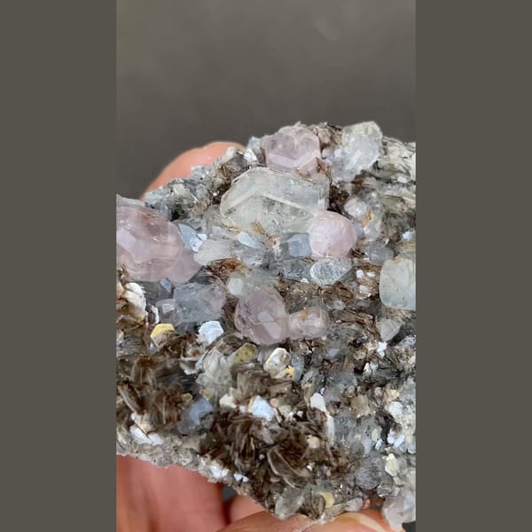 Pale violet apatite with aquamarine on mica from Xuebaoding, Sichuan — alternate view