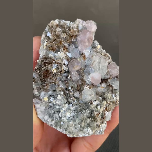Pale violet apatite with aquamarine on mica from Xuebaoding, Sichuan — detail view