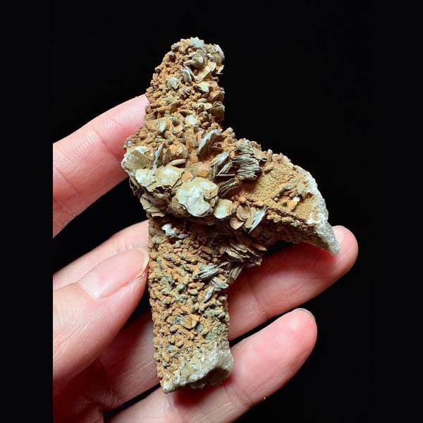Mud-coated quartz floater with petal calcite from Inner Mongolia — complete view
