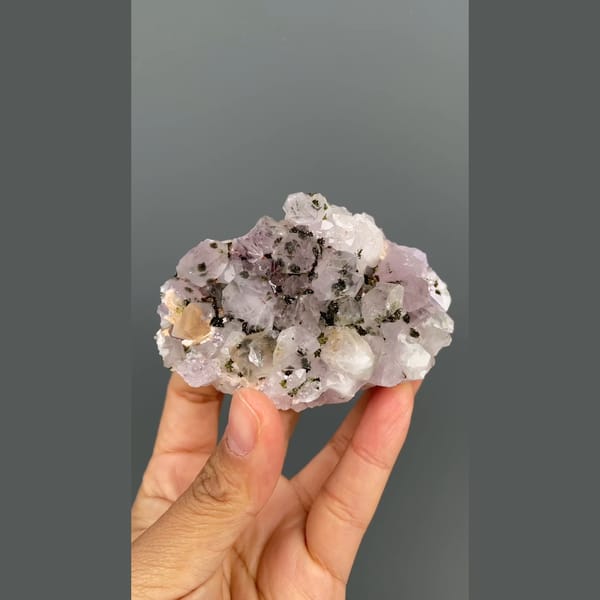 Lilac-white quartz cluster with dark epidote from Meigu, Sichuan — complete view