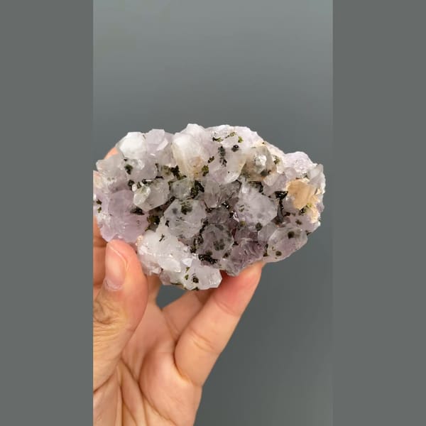 Lilac-white quartz cluster with dark epidote from Meigu, Sichuan — alternate view