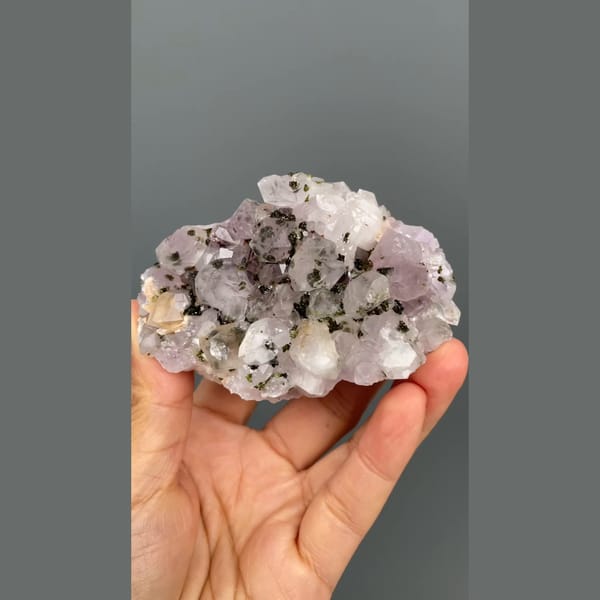 Lilac-white quartz cluster with dark epidote from Meigu, Sichuan — detail view