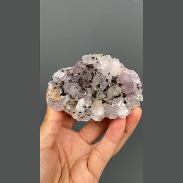 Lilac-white quartz cluster with dark epidote from Meigu, Sichuan — detail view