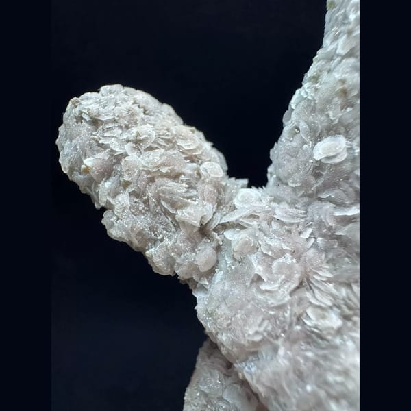 Crossed quartz floater with pale pink petal calcite from Inner Mongolia — detail view
