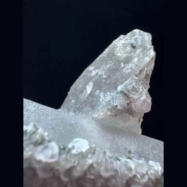 Crossed quartz floater with pale pink petal calcite from Inner Mongolia — detail view