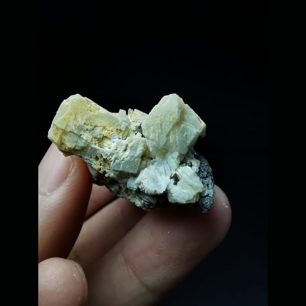 Platy loellingite with two calcite crystals from Huanggangliang — alternate view