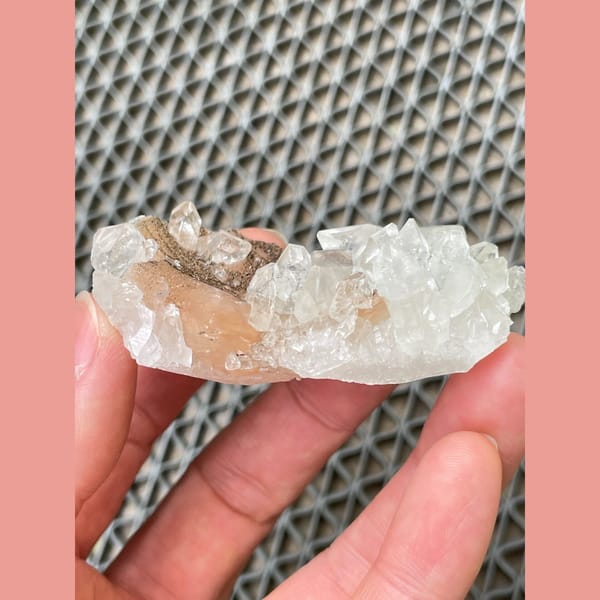 Clear apophyllite with peach stilbite from India — detail view