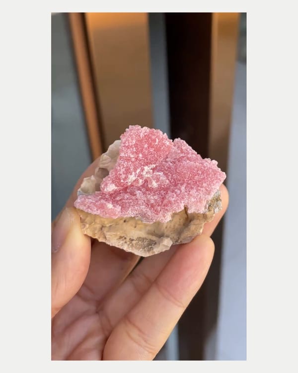 Complete right oblique view of pink rhodochrosite specimen