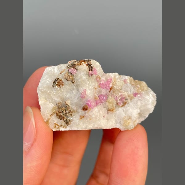 Pink-red corundum in white marble from Yunnan — detail view