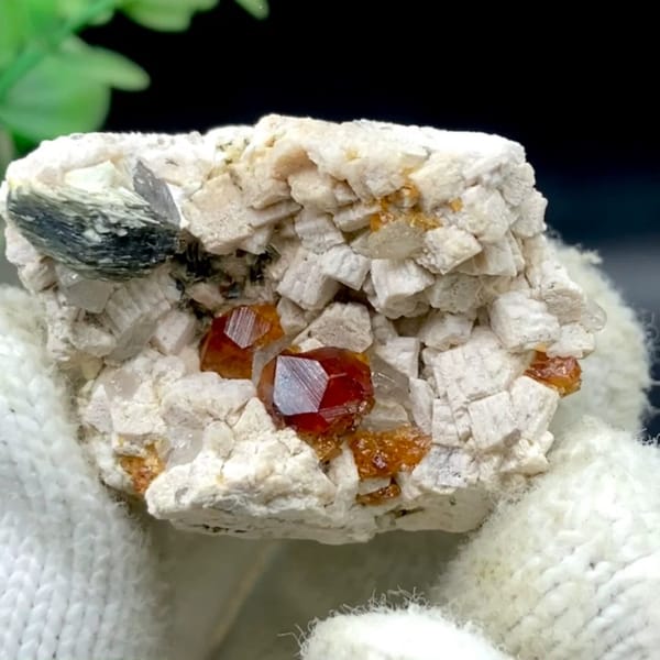 Orange red garnet clusters in feldspar with mica — complete view