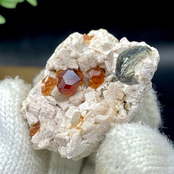 Orange red garnet clusters in feldspar with mica — alternate view
