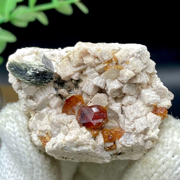 Orange red garnet clusters in feldspar with mica — detail view