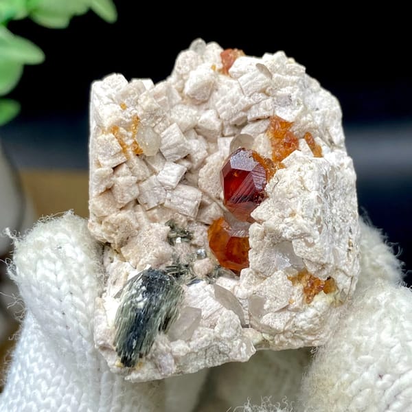 Orange red garnet clusters in feldspar with mica — detail view