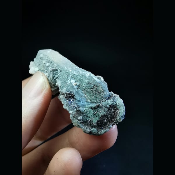 Floater quartz with specular hematite and white calcite — detail view