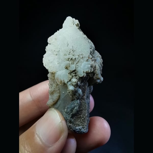 Quartz crystal capped with a thick calcite coating — complete view