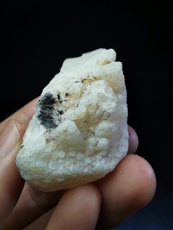 Complete reverse face showing dark specular hematite on calcite