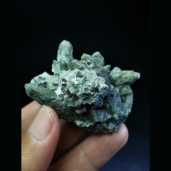 Green quartz cluster with a green calcite ball and hematite — complete view