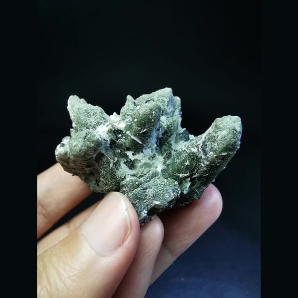 Green quartz cluster with a green calcite ball and hematite — alternate view