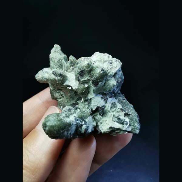 Green quartz cluster with a green calcite ball and hematite — alternate view