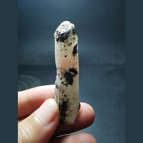 Red hematoid quartz crystal with specular hematite — complete view