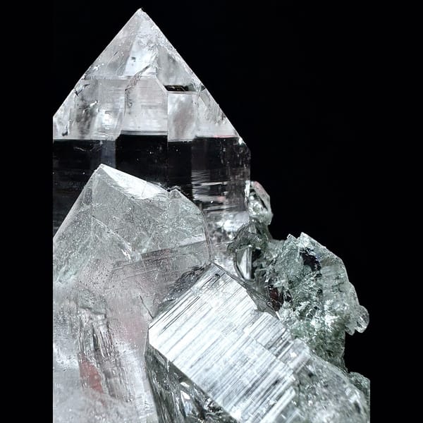 Clear Himalayan quartz cluster with green phantom base from India — detail view