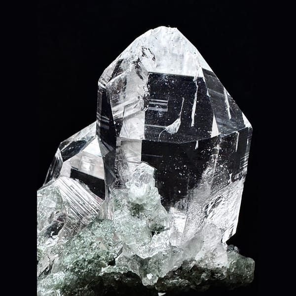 Clear Himalayan quartz cluster with green phantom base from India — detail view