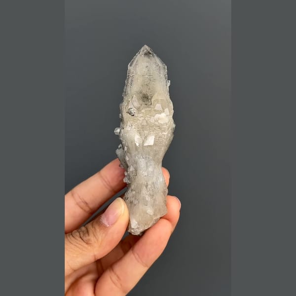 Elongated quartz crystal group with dark mineral accents from Inner Mongolia — complete view