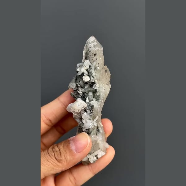 Elongated quartz crystal group with dark mineral accents from Inner Mongolia — alternate view