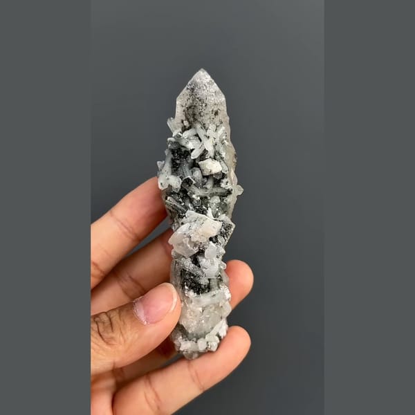 Elongated quartz crystal group with dark mineral accents from Inner Mongolia — alternate view