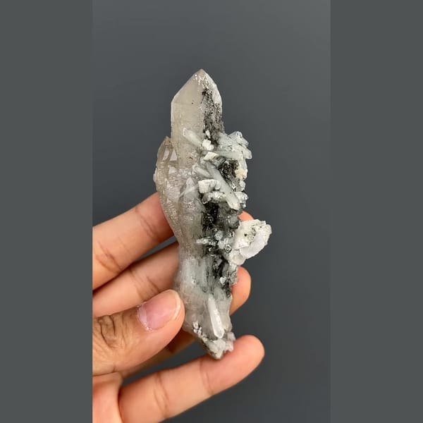 Elongated quartz crystal group with dark mineral accents from Inner Mongolia — detail view