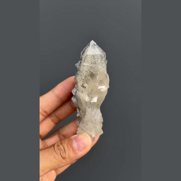 Elongated quartz crystal group with dark mineral accents from Inner Mongolia — detail view