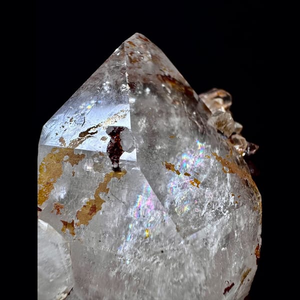 Double-terminated quartz floater with golden crust from Hashupi, Pakistan — detail view