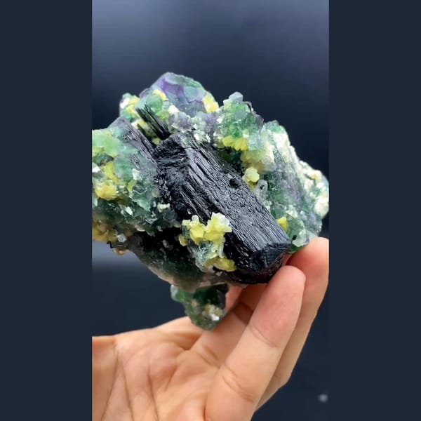 Green cubic fluorite with yellow mica and black tourmaline from South Africa — detail view