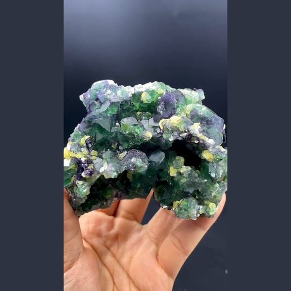 Green cubic fluorite with yellow mica and black tourmaline from South Africa — detail view