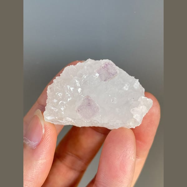 Pale pink fluorite crystals on white quartz from Zhejiang — complete view