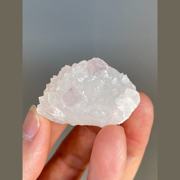 Pale pink fluorite crystals on white quartz from Zhejiang — alternate view