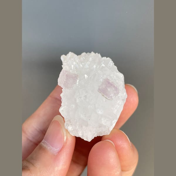 Pale pink fluorite crystals on white quartz from Zhejiang — detail view