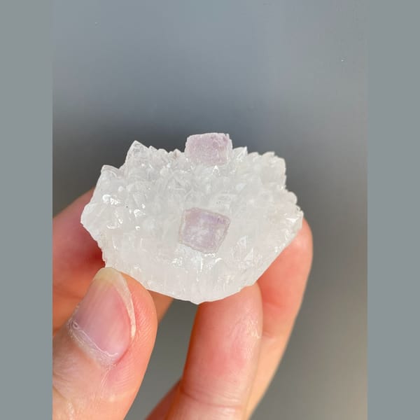 Pale pink fluorite crystals on white quartz from Zhejiang — detail view