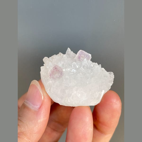 Pale pink fluorite crystals on white quartz from Zhejiang — detail view