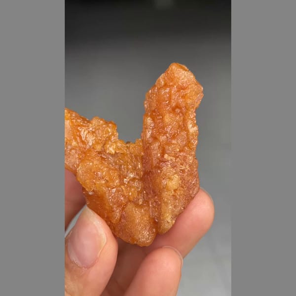 Unusual V-shaped orange scheelite formation from Xuebaoding — alternate view