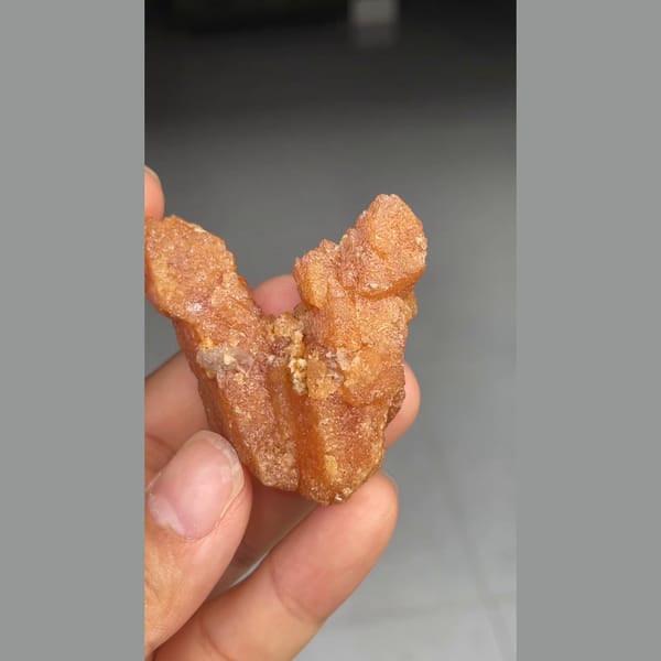 Unusual V-shaped orange scheelite formation from Xuebaoding — detail view