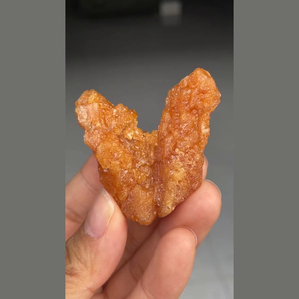 Unusual V-shaped orange scheelite formation from Xuebaoding — detail view