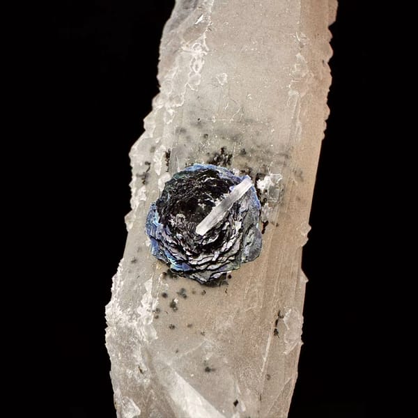 Pale quartz crystal with a specular hematite rosette from Inner Mongolia — detail view