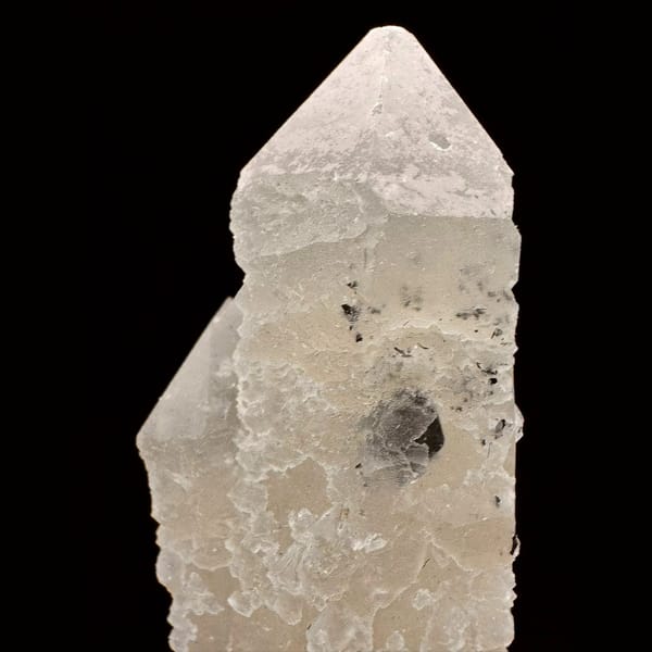 Pale quartz crystal with a specular hematite rosette from Inner Mongolia — detail view