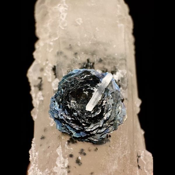 Pale quartz crystal with a specular hematite rosette from Inner Mongolia — detail view