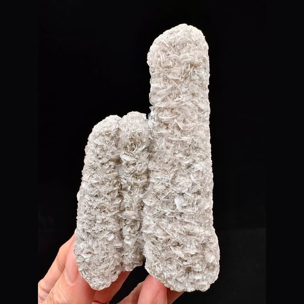 Twin sparkly quartz crystals with pale pink petal calcite from Inner Mongolia — complete view