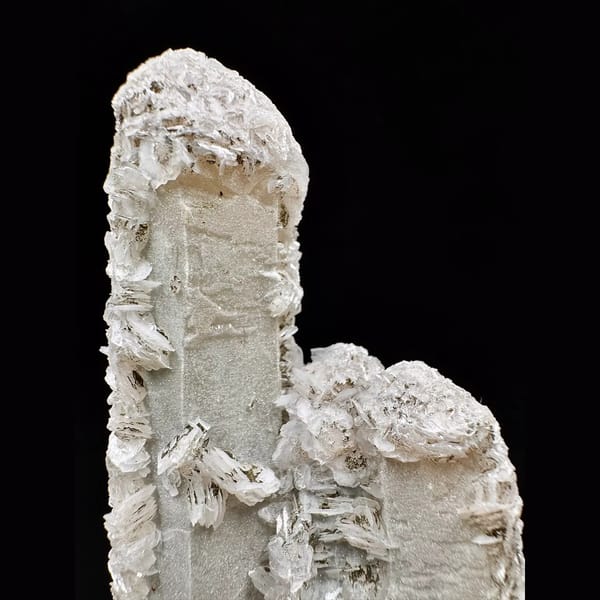 Twin sparkly quartz crystals with pale pink petal calcite from Inner Mongolia — detail view