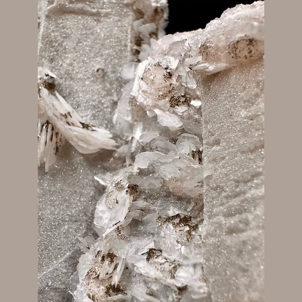 Twin sparkly quartz crystals with pale pink petal calcite from Inner Mongolia — detail view